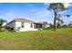 Backyard view featuring a well-maintained lawn and view of the rear of the property at 4378 Summertree Rd, Venice, FL 34293