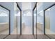Bathroom with double sink vanity, walk-in shower, and a glass block wall for natural light at 4378 Summertree Rd, Venice, FL 34293