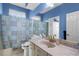 This bathroom features a marble vanity, a large mirror, and a shower with a leaf patterned curtain at 4378 Summertree Rd, Venice, FL 34293