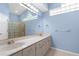 Bright bathroom with double sinks, quartz counters, and a glass block shower at 4378 Summertree Rd, Venice, FL 34293