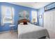 Charming bedroom with white bedding, two windows, and a built-in closet at 4378 Summertree Rd, Venice, FL 34293