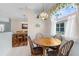 Bright breakfast nook with tile flooring, a round table, and an adjacent dining room at 4378 Summertree Rd, Venice, FL 34293