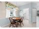 Cozy breakfast nook with a round table, natural light, and a view to the laundry room at 4378 Summertree Rd, Venice, FL 34293