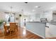 Open-concept dining and kitchen area featuring hardwood floors and a breakfast bar at 4378 Summertree Rd, Venice, FL 34293