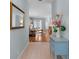 Inviting foyer featuring tile floors, light blue walls, and a glimpse into the living room at 4378 Summertree Rd, Venice, FL 34293