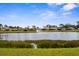 Scenic lake view showcasing the neighborhood, with a fountain adding to the tranquil atmosphere at 4378 Summertree Rd, Venice, FL 34293