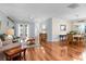 Spacious living room with hardwood floors, French doors, and a dining area at 4378 Summertree Rd, Venice, FL 34293