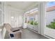 Cozy sunroom with wicker chair, white walls and tiled floor, offering a relaxing view at 4378 Summertree Rd, Venice, FL 34293