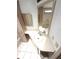 Bathroom sink and vanity with overhead lighting and a mirrored cabinet at 453 Sharks Pt, North Port, FL 34287