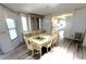 Bright dining room features a large table with seating for six and hardwood flooring at 453 Sharks Pt, North Port, FL 34287
