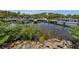 Waterfront view of the community docks with multiple boat slips, lush landscaping, and blue skies overhead at 453 Sharks Pt, North Port, FL 34287