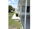 Exterior view of home with covered porch, manicured lawn and landscaping at 453 Sharks Pt, North Port, FL 34287