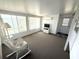 Bright living room with white wicker furniture and abundant natural light at 453 Sharks Pt, North Port, FL 34287