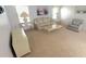 Comfortable living room with a patterned sofa and chair, neutral carpet and soft, natural light at 453 Sharks Pt, North Port, FL 34287