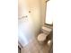 Bathroom featuring a toilet, tile floors, and a window with blinds at 453 Sharks Pt, North Port, FL 34287