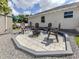 Charming backyard patio featuring a fire pit, seating area, and well-maintained landscaping for outdoor enjoyment at 460 Bard Rd, Venice, FL 34293