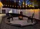 Backyard features pavers, artificial turf, white vinyl fencing, lighting, and fire pit at 460 Bard Rd, Venice, FL 34293