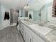Luxurious bathroom with a double vanity, granite counters, and a glass-enclosed shower at 460 Bard Rd, Venice, FL 34293
