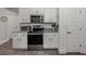 This kitchen features stainless steel appliances, white cabinets, and granite countertops for a modern feel at 460 Bard Rd, Venice, FL 34293