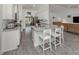 Well-lit kitchen featuring granite countertops, modern appliances, and an island with seating at 460 Bard Rd, Venice, FL 34293