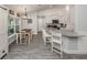 Open-concept kitchen with white cabinetry, granite countertops, and a dining area at 460 Bard Rd, Venice, FL 34293