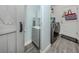 Well-designed laundry room with wood-look tile flooring, storage, and modern machines at 460 Bard Rd, Venice, FL 34293
