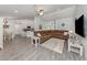 Spacious living room with vaulted ceilings, modern floors, ceiling fan, and a comfortable couch at 460 Bard Rd, Venice, FL 34293