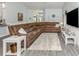 Spacious living room with a plush sectional sofa, wood-look floors, and coastal decor at 460 Bard Rd, Venice, FL 34293
