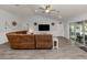 Spacious living room with vaulted ceilings, modern floors, ceiling fan, and a comfortable couch at 460 Bard Rd, Venice, FL 34293