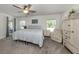 Cozy main bedroom with neutral tones, ample natural light, and a comfortable sitting area at 460 Bard Rd, Venice, FL 34293