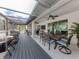 Spacious covered patio with an outdoor kitchen, dining area, and seating, perfect for entertaining at 460 Bard Rd, Venice, FL 34293