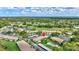 Enjoy this community aerial view with golf course, mature trees, condo pool, and covered parking at 4646 Longwater Chase # 98, Sarasota, FL 34235
