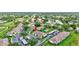 An aerial view of the condo with nearby community pool, covered parking, and lush landscaping at 4646 Longwater Chase # 98, Sarasota, FL 34235