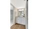 Bathroom with a marble vanity and updated lighting fixtures with a glass shower at 4646 Longwater Chase # 98, Sarasota, FL 34235