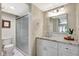 Bathroom with a glass shower, a marble vanity, and updated light fixtures at 4646 Longwater Chase # 98, Sarasota, FL 34235