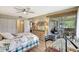 Bright bedroom with a ceiling fan, a walk-in closet, and access to the balcony at 4646 Longwater Chase # 98, Sarasota, FL 34235