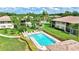 Aerial view of the community pool, set amongst lush landscaping and well-maintained buildings at 4646 Longwater Chase # 98, Sarasota, FL 34235