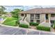 Inviting condo exterior with lush green spaces, convenient parking, and a tranquil neighborhood vibe at 4646 Longwater Chase # 98, Sarasota, FL 34235
