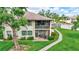 Lovely outdoor living space features a screened lanai and covered balcony overlooking well-maintained landscaping at 4646 Longwater Chase # 98, Sarasota, FL 34235