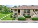 Well-maintained condo exterior with landscaped grounds, private entrance, and convenient parking at 4646 Longwater Chase # 98, Sarasota, FL 34235