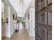 View of the foyer featuring wood floors, white trim and an open doorway to a screened lanai at 4646 Longwater Chase # 98, Sarasota, FL 34235