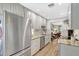 An updated kitchen with stainless steel appliances, granite countertops and white cabinets at 4646 Longwater Chase # 98, Sarasota, FL 34235