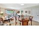Cozy living and dining area with wood floors and access to a screened outdoor lanai at 4646 Longwater Chase # 98, Sarasota, FL 34235