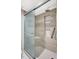 Modern bathroom with a tiled shower that includes a built-in seat and shelving niche at 4646 Longwater Chase # 98, Sarasota, FL 34235