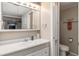 Bathroom featuring a vanity, sink, mirrored cabinet, and view of the toilet at 491 Cervina Dr, Venice, FL 34285
