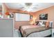 Bedroom featuring a ceiling fan, window, and comfortable bed with decorative pillows at 491 Cervina Dr, Venice, FL 34285