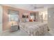 Comfortable bedroom with a ceiling fan, bedside tables, and decor, next to the bathroom at 491 Cervina Dr, Venice, FL 34285