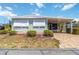 Charming single-story home with a covered carport and well-maintained landscaping and brick paved drive way at 491 Cervina Dr, Venice, FL 34285
