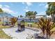 Community grilling area with modern grill, picnic table, landscaping, and inviting signage at 491 Cervina Dr, Venice, FL 34285