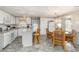 Open kitchen with modern appliances, island seating, adjacent dining area, and great natural light at 491 Cervina Dr, Venice, FL 34285